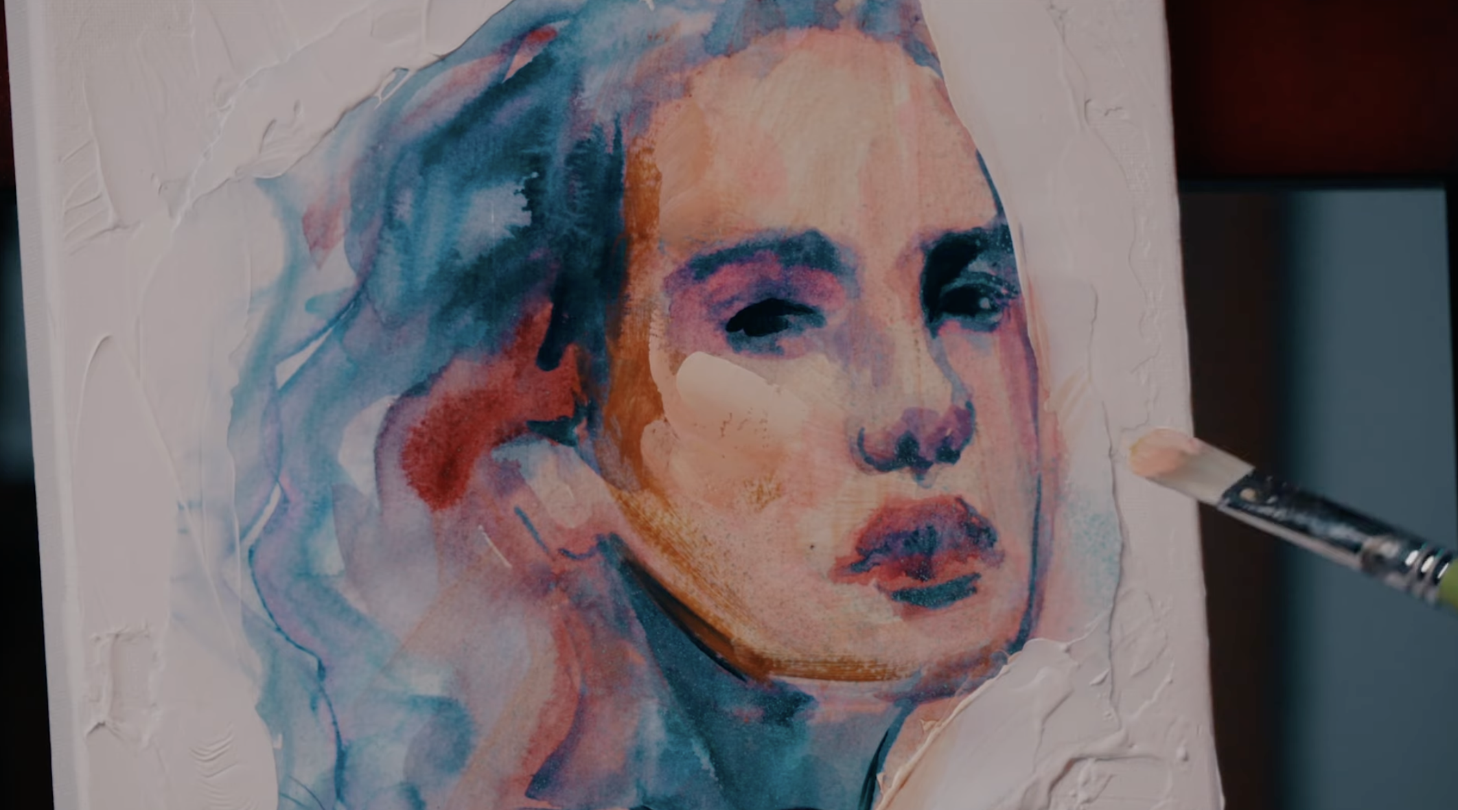 Portrait of blue pink and peach paint colors with paint brush